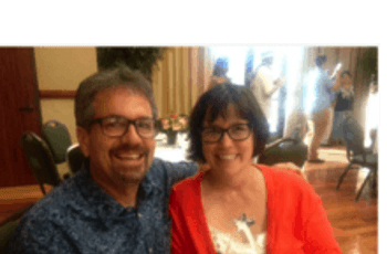 photo of Mrs. Contreras and her husband sitting at a table