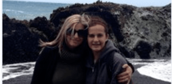 photo of Ms. Harris and her daughter in front of some rocks at a beach